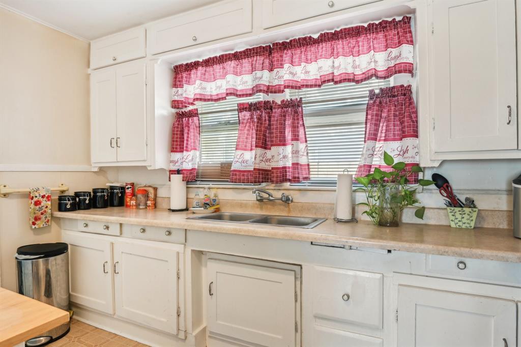 2509 Bird Street Fort Worth, TX 76111 - Photo 6 of 30 a kitchen with white cabinets and sink