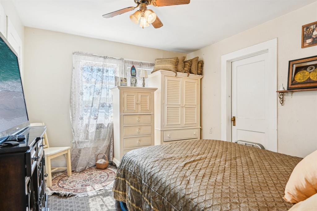 2509 Bird Street Fort Worth, TX 76111 - Photo 10 of 30 a bedroom with a bed and a television