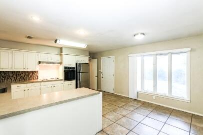2517 33rd Street Lubbock, TX 79410 - Photo 21 of 50 a large bathroom with a large mirror vanity and shower