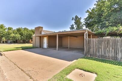 2517 33rd Street Lubbock, TX 79410 - Photo 5 of 50 a backyard of a house with table and chairs