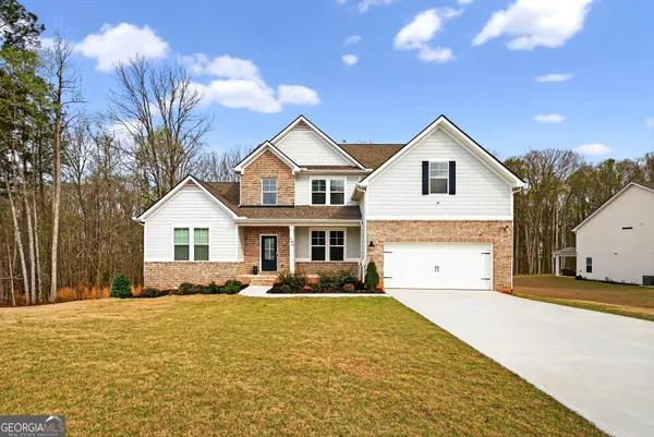 a front view of a house with a yard and garage
