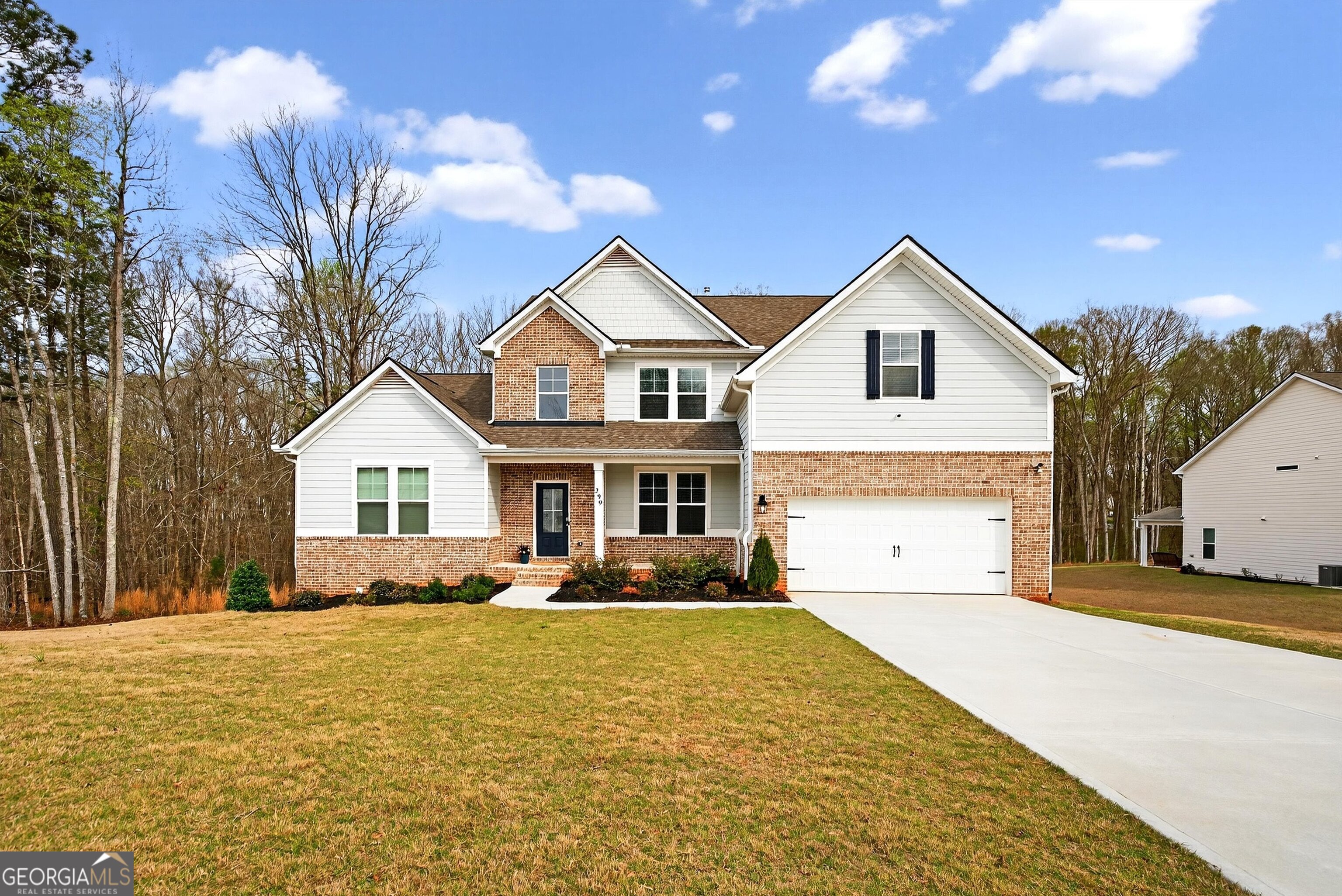 299 Saddleridge Trail Senoia, GA 30276 - Photo 1 of 56 a front view of a house with a yard and garage