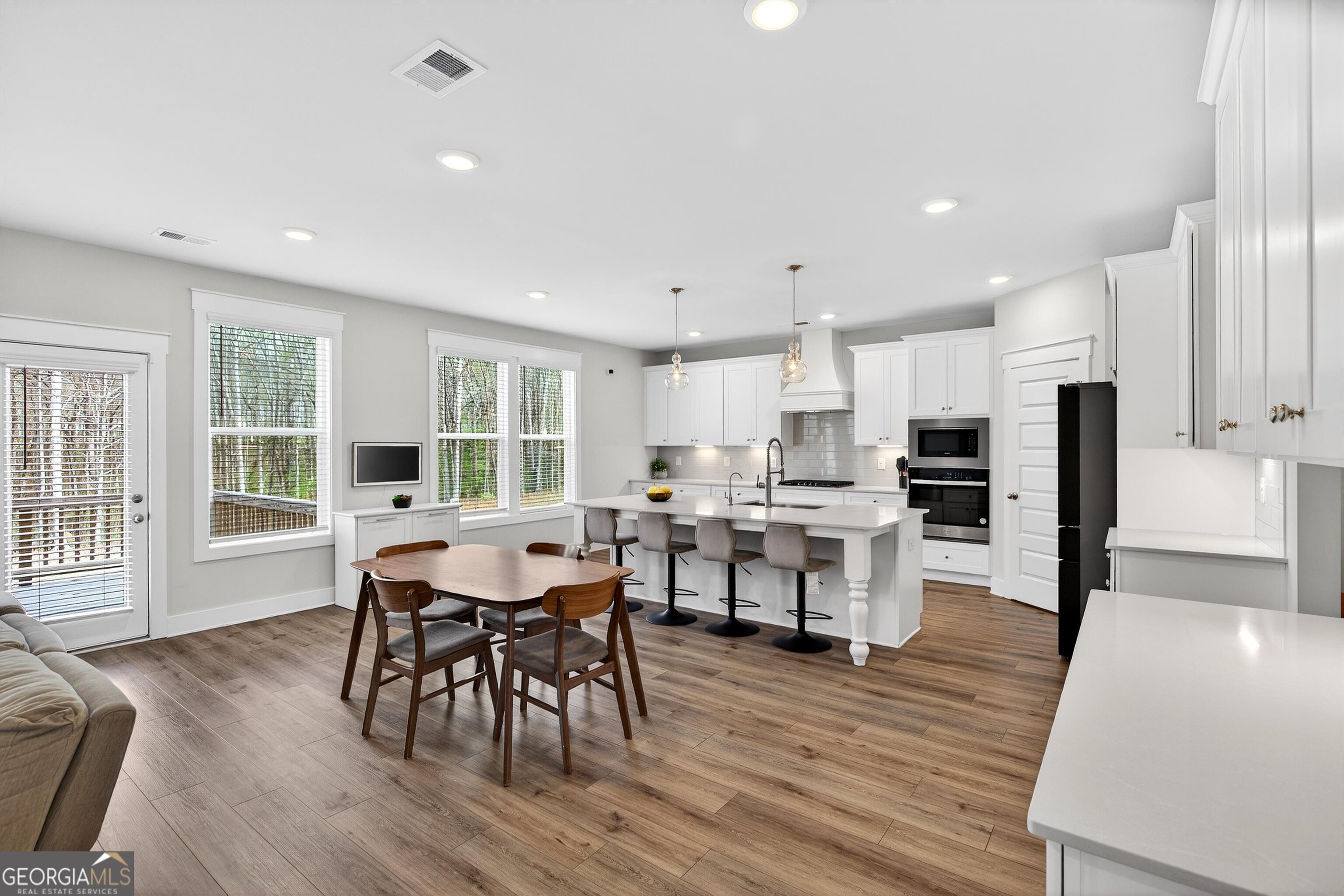 299 Saddleridge Trail Senoia, GA 30276 - Photo 12 of 56 a view of a dining room with furniture and wooden floor