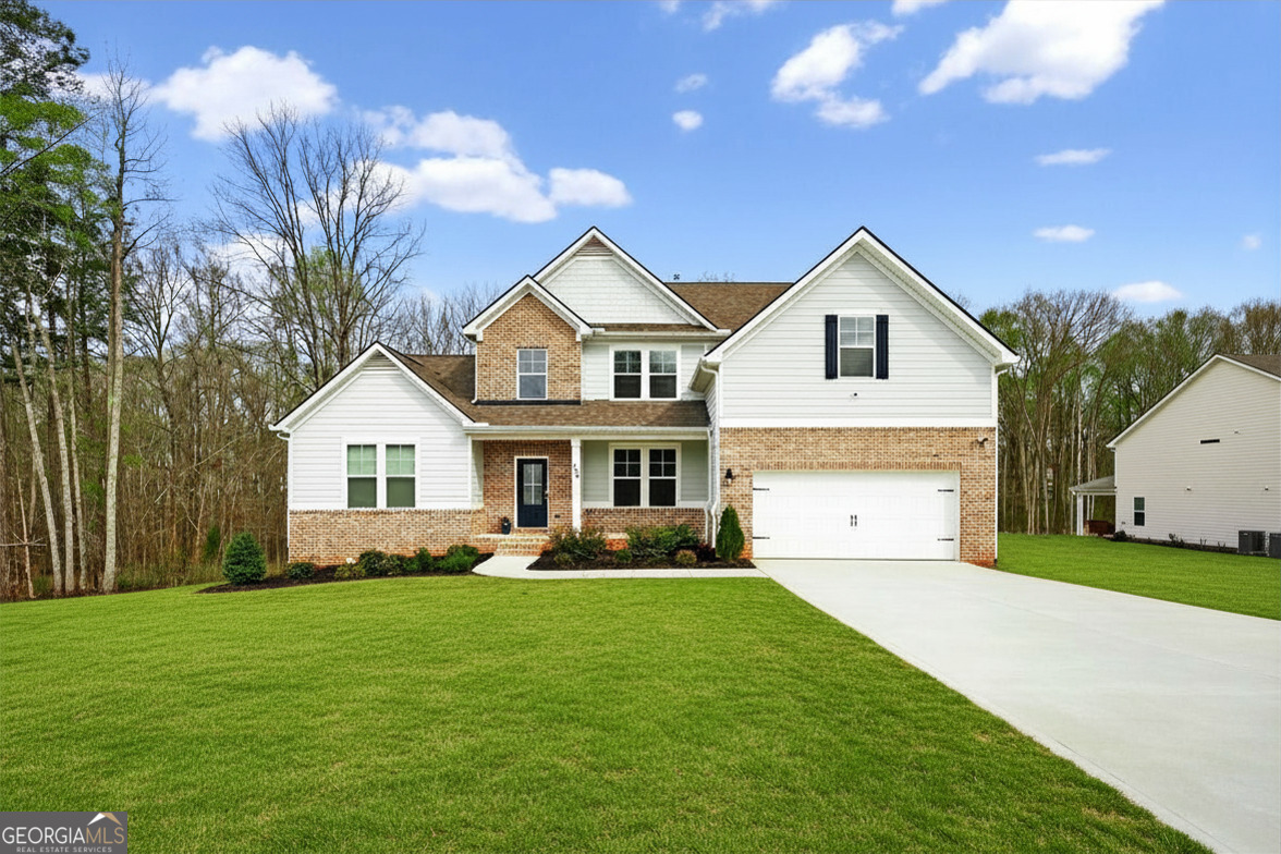 299 Saddleridge Trail Senoia, GA 30276 - Photo 2 of 56 a front view of house with yard and green space