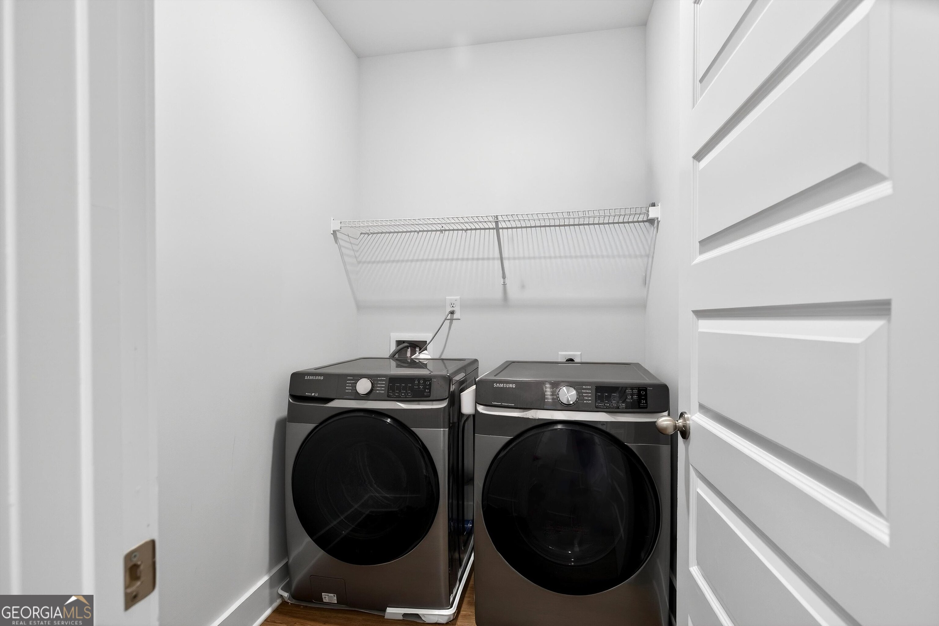 299 Saddleridge Trail Senoia, GA 30276 - Photo 21 of 56 a utility room with dryer washer and empty racks