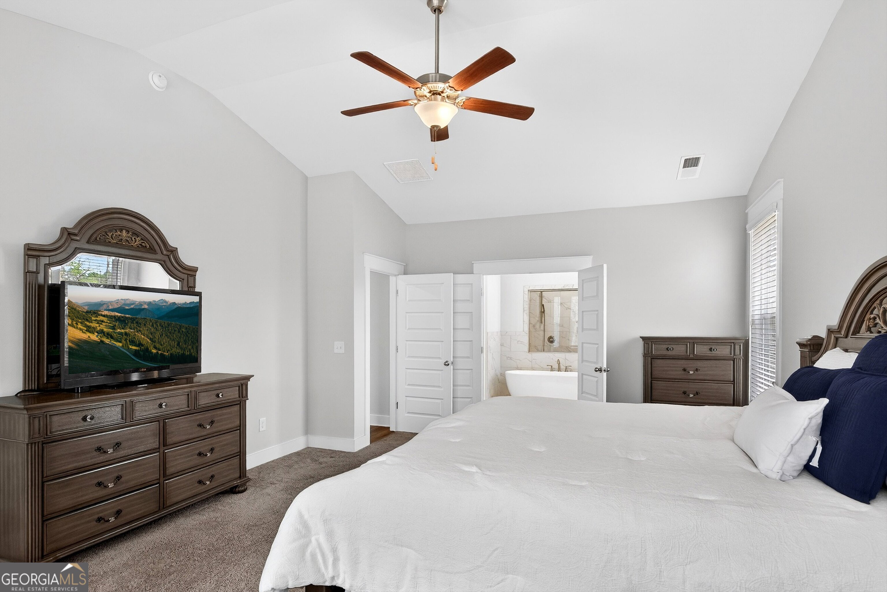 299 Saddleridge Trail Senoia, GA 30276 - Photo 24 of 56 a bedroom with a bed and a flat screen tv