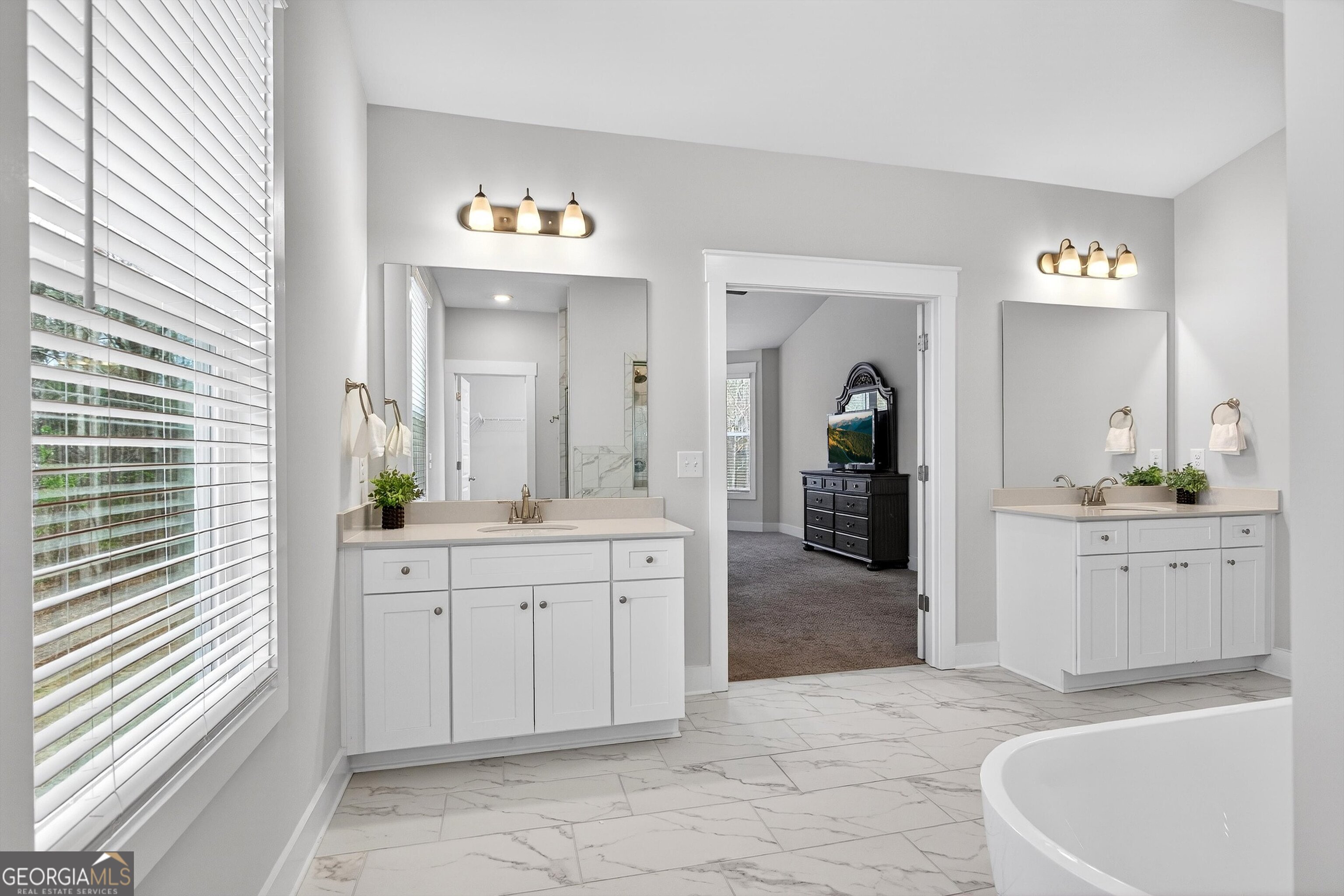 299 Saddleridge Trail Senoia, GA 30276 - Photo 29 of 56 a large white kitchen with a sink and a large mirror
