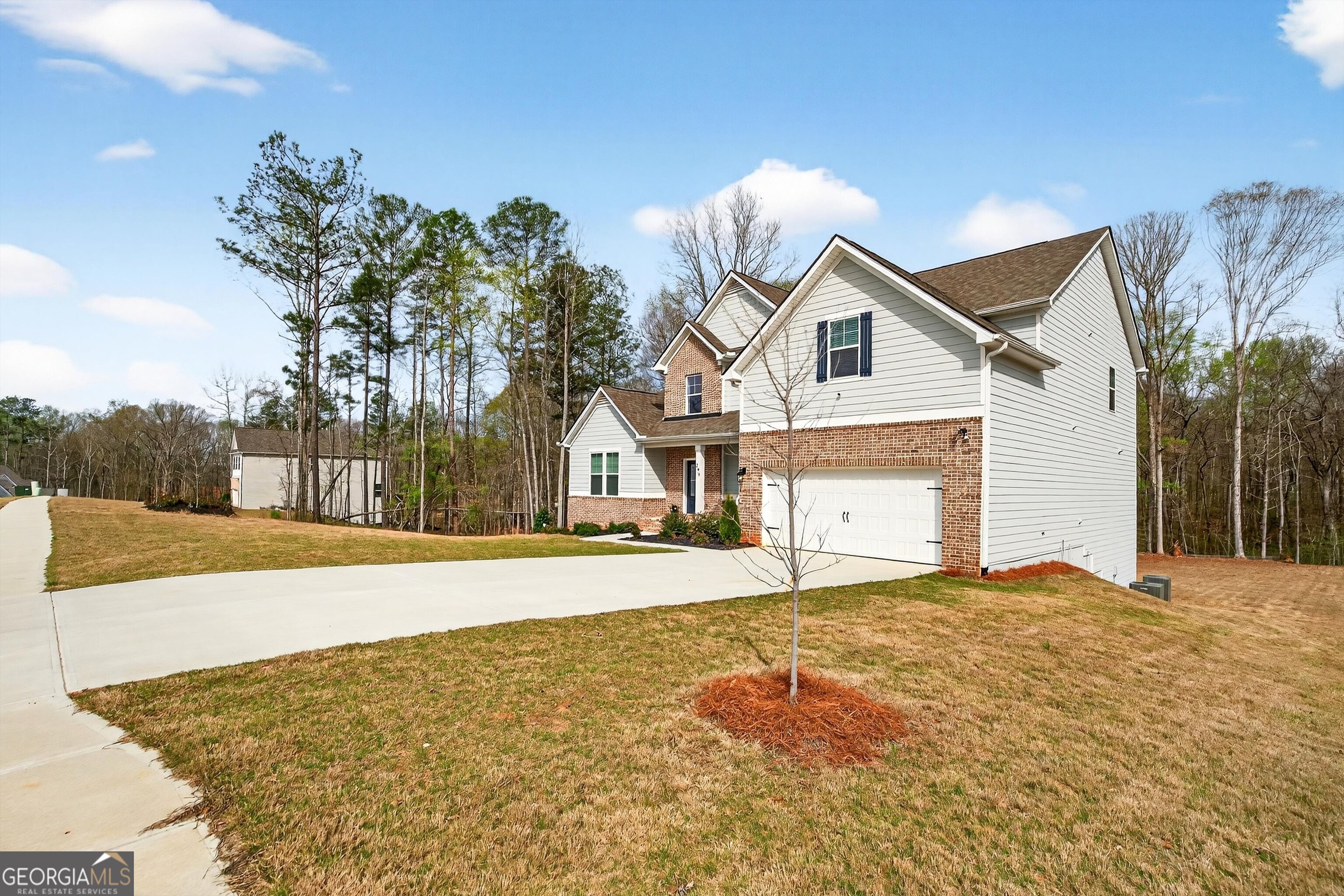 299 Saddleridge Trail Senoia, GA 30276 - Photo 54 of 56 a front view of a house with a yard and garage