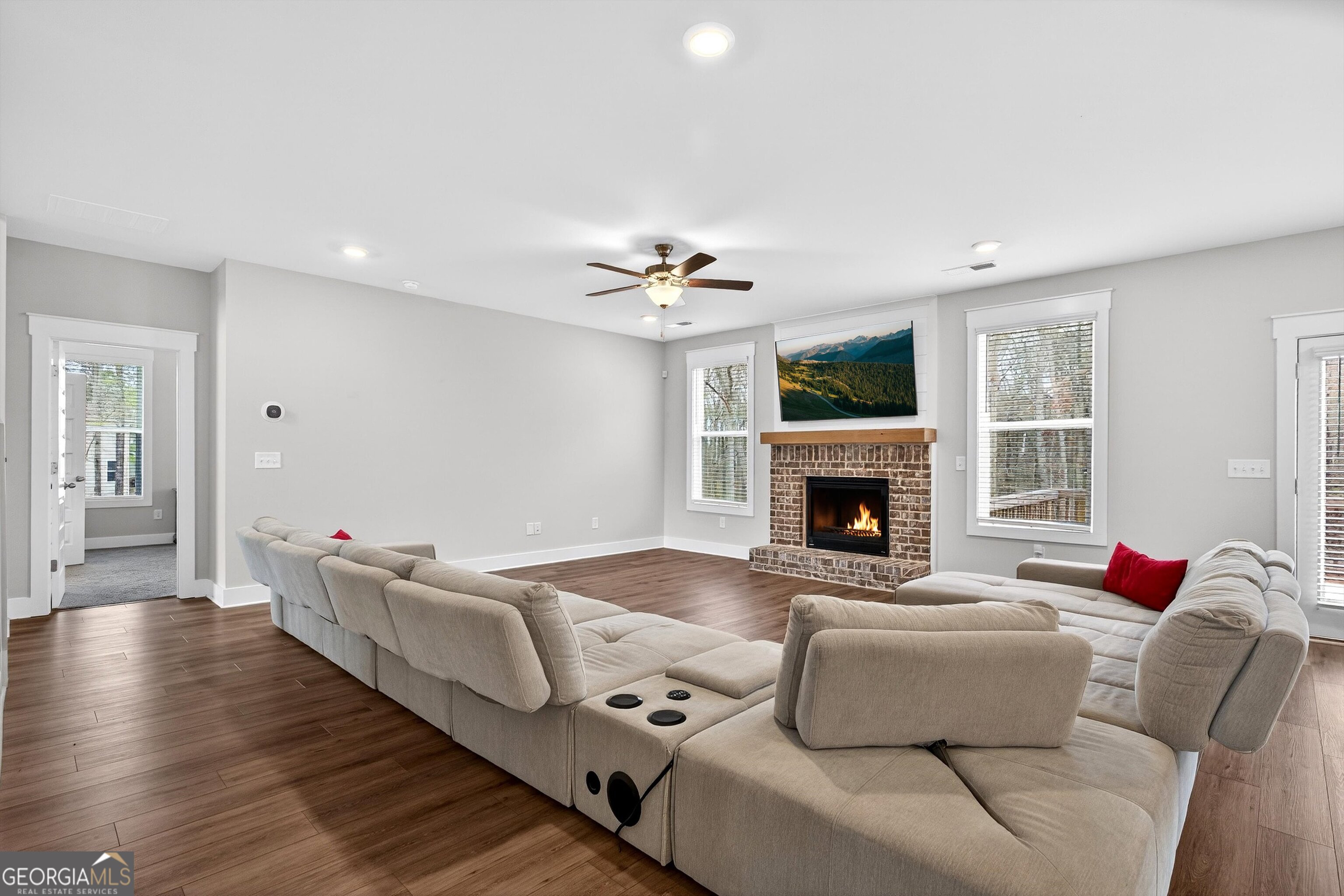 299 Saddleridge Trail Senoia, GA 30276 - Photo 8 of 56 a living room with furniture fireplace and a flat screen tv