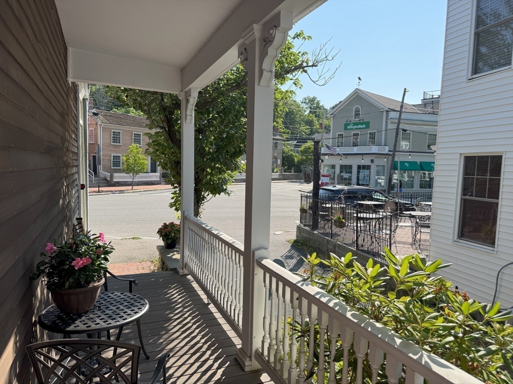 31 South Main Street, Unit 31 Cohasset, MA 02025 - Photo 13 of 30 a balcony with outdoor seating and flowers