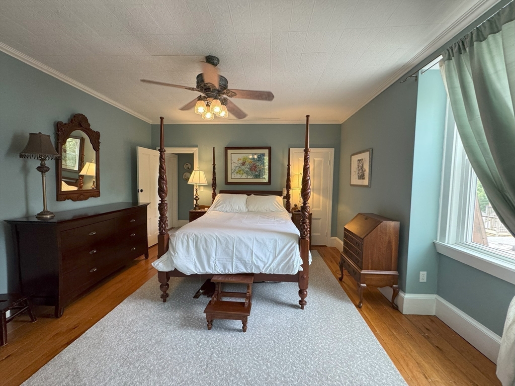 31 South Main Street, Unit 31 Cohasset, MA 02025 - Photo 15 of 30 a bedroom with a bed and wooden floor