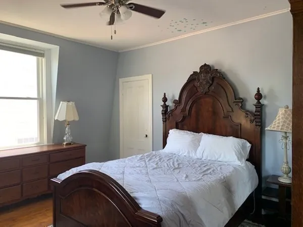 a bedroom with a bed and a window