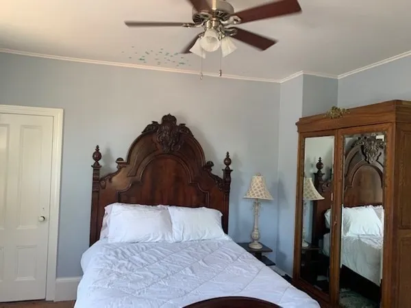 a bedroom with a bed and walk in closet