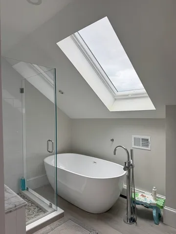 a bathroom with a bathtub and shower