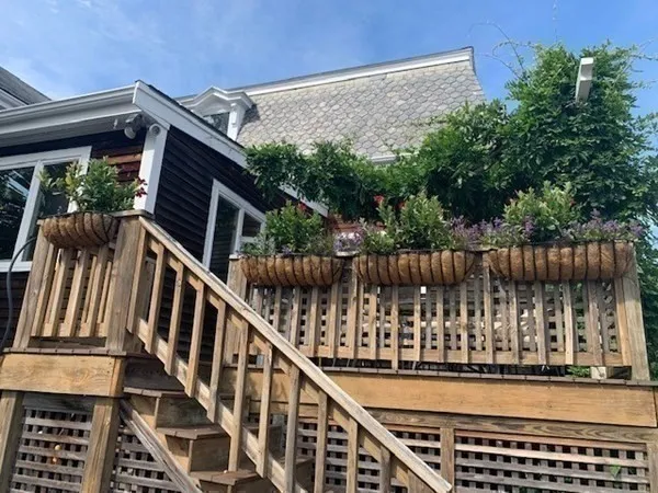 a view of balcony with wooden floor and fence