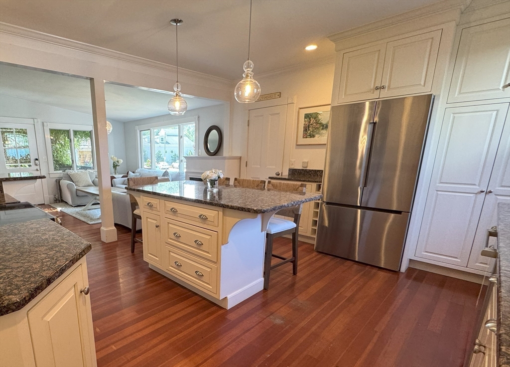 31 South Main Street, Unit 31 Cohasset, MA 02025 - Photo 3 of 30 a kitchen with stainless steel appliances granite countertop a refrigerator a sink dishwasher a stove with white cabinets and wooden floor