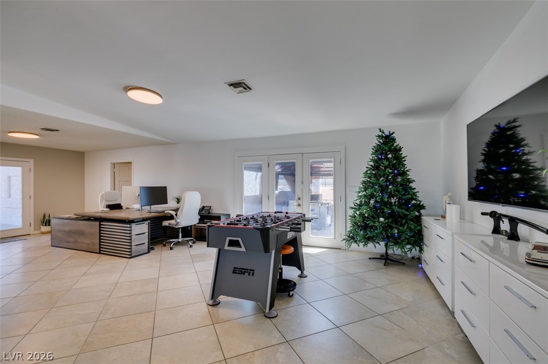 892 North Hollywood Boulevard Las Vegas, NV 89110 - Photo 26 of 81 This versatile room features expansive tiled flooring and provides direct outdoor access through its elegant French doors.