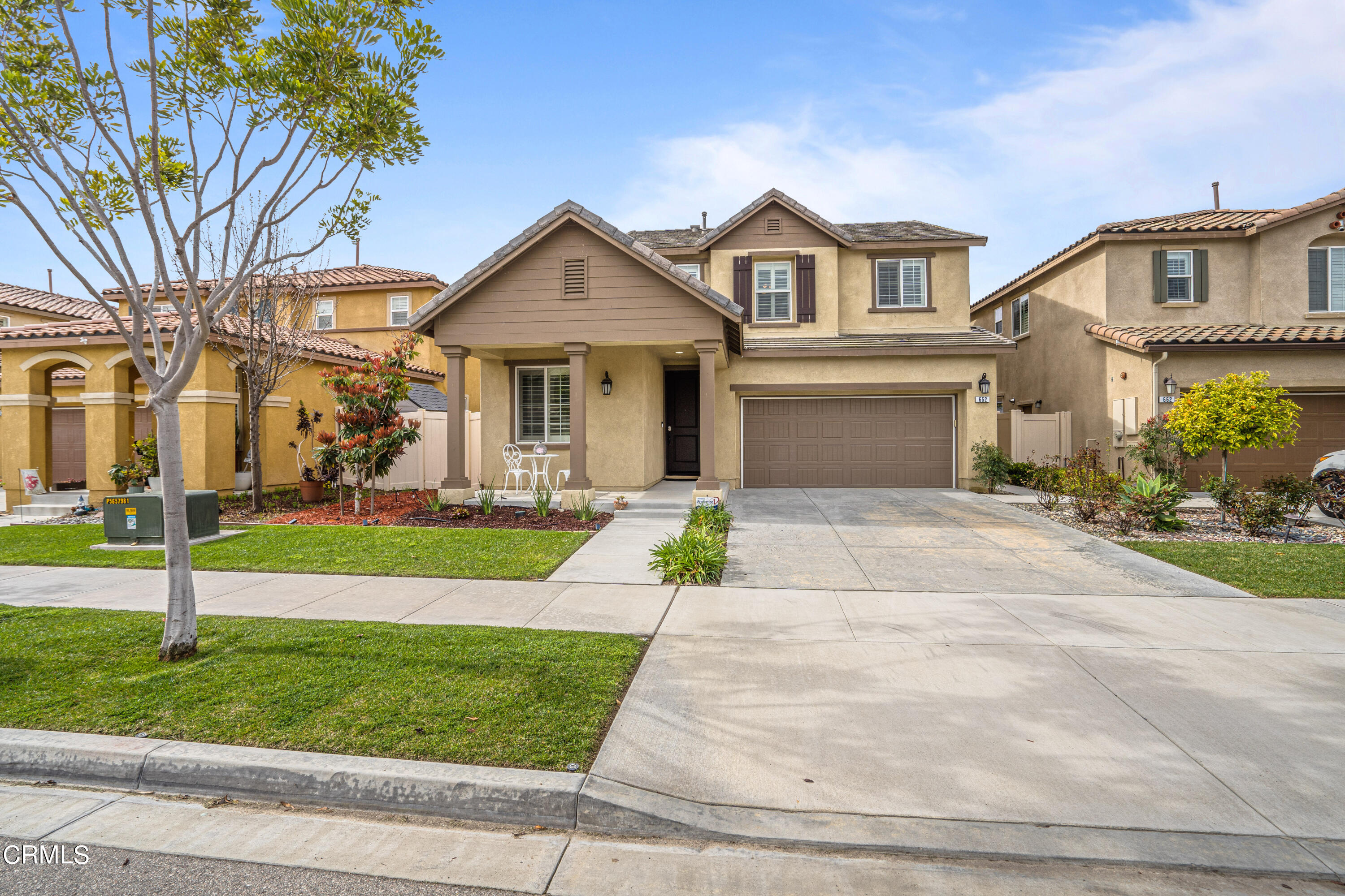 652 Xanadu Way Oxnard, CA 93036 - Photo 17 of 68 a front view of a house with a yard and garage