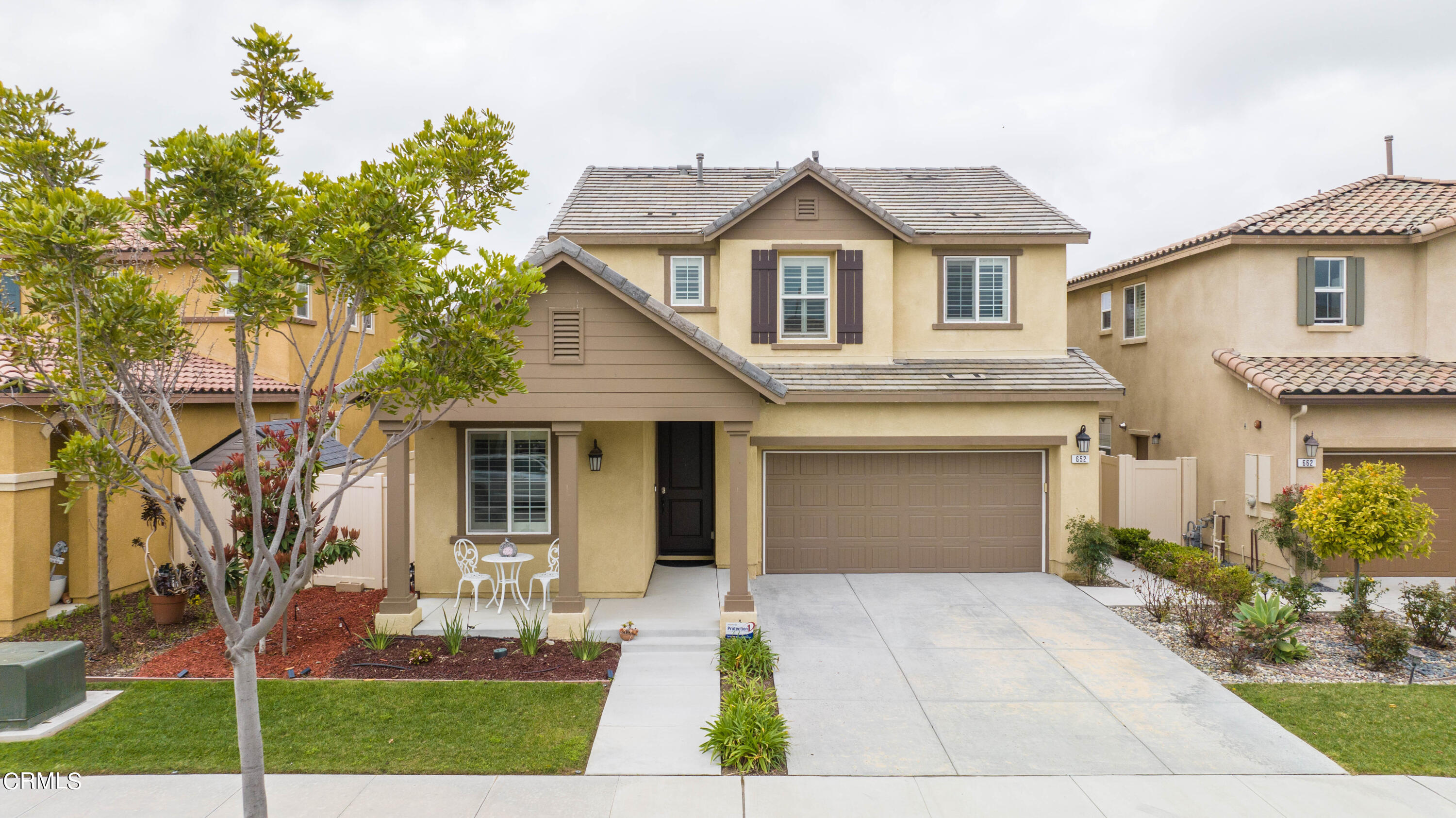 652 Xanadu Way Oxnard, CA 93036 - Photo 21 of 68 a front view of a house with a yard and potted plants