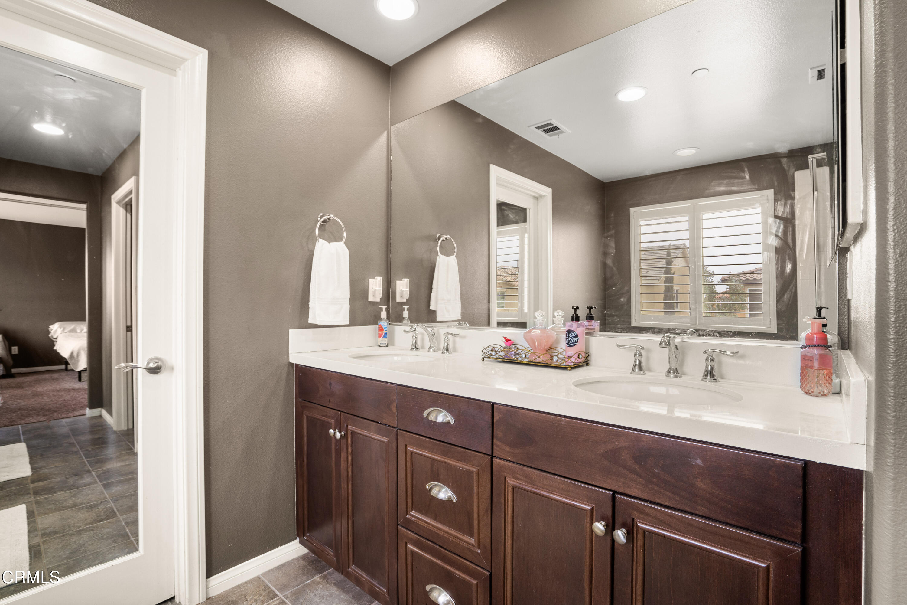 652 Xanadu Way Oxnard, CA 93036 - Photo 50 of 68 a bathroom with a double vanity sink and a mirror