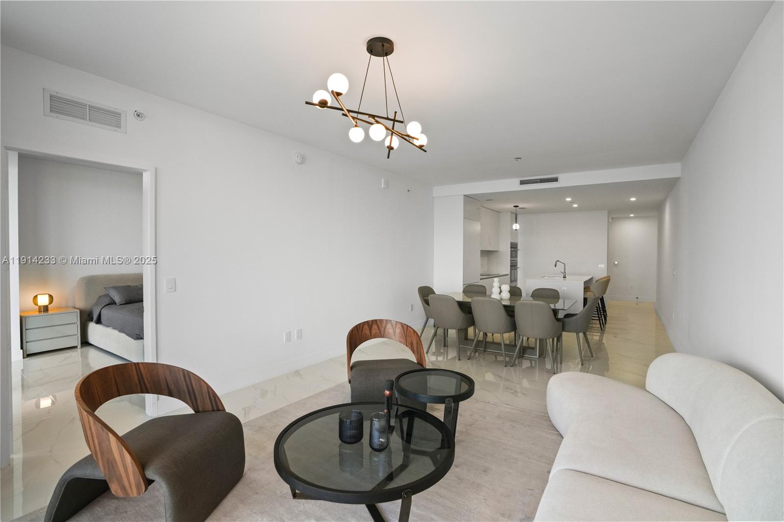 700 Northeast 24th Street, Unit 3905 Miami, FL 33137 - Photo 12 of 46 a living room with furniture a mirror and a lamp