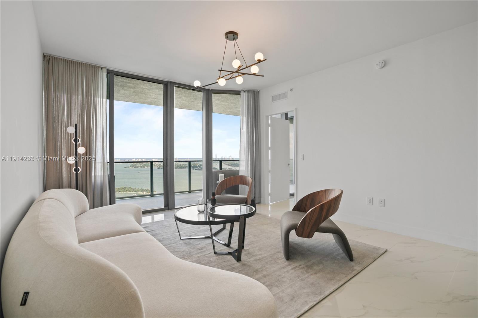 700 Northeast 24th Street, Unit 3905 Miami, FL 33137 - Photo 13 of 46 a living room with furniture and a large window