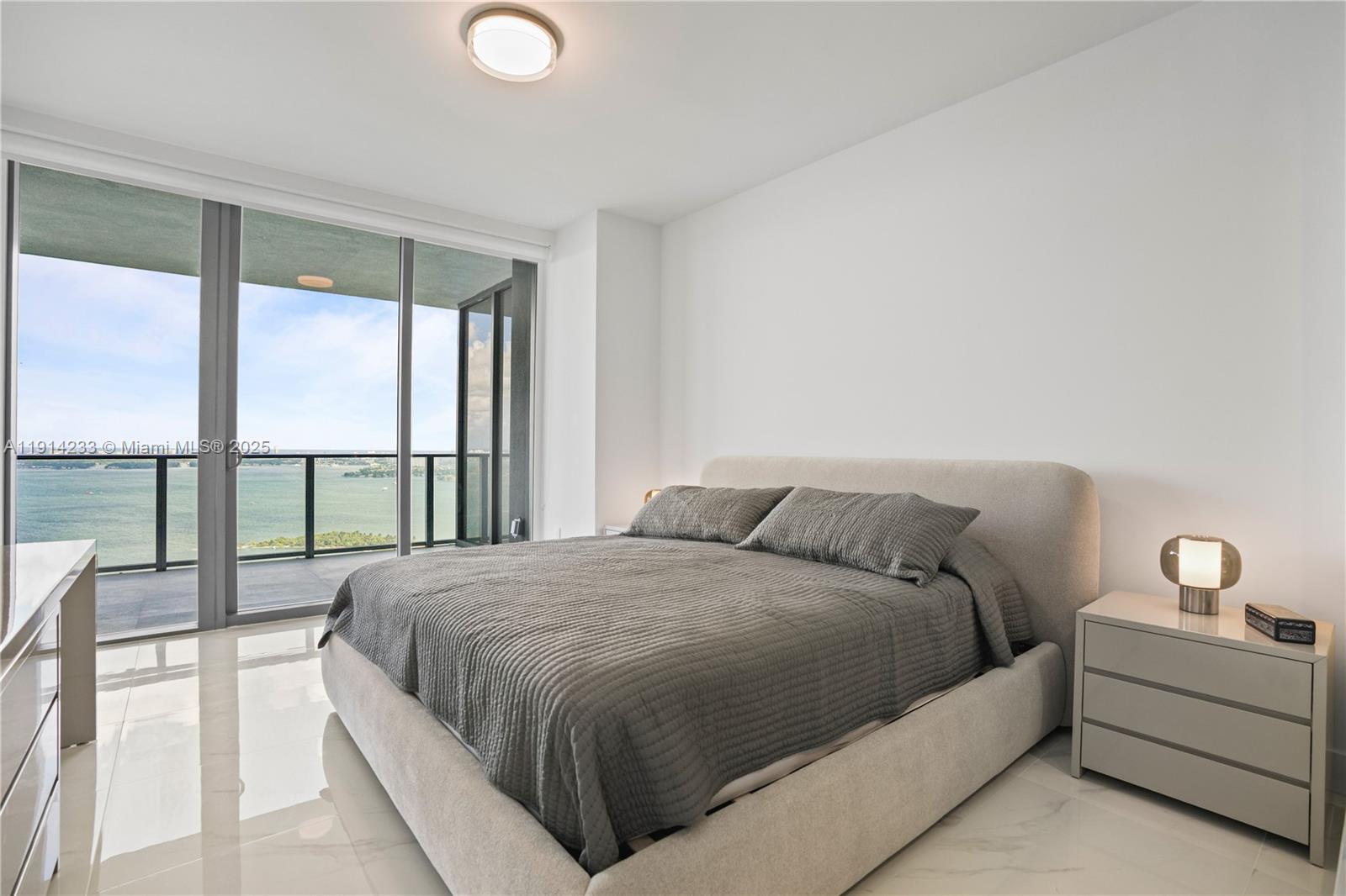 700 Northeast 24th Street, Unit 3905 Miami, FL 33137 - Photo 15 of 46 a bedroom with a large bed and a large window