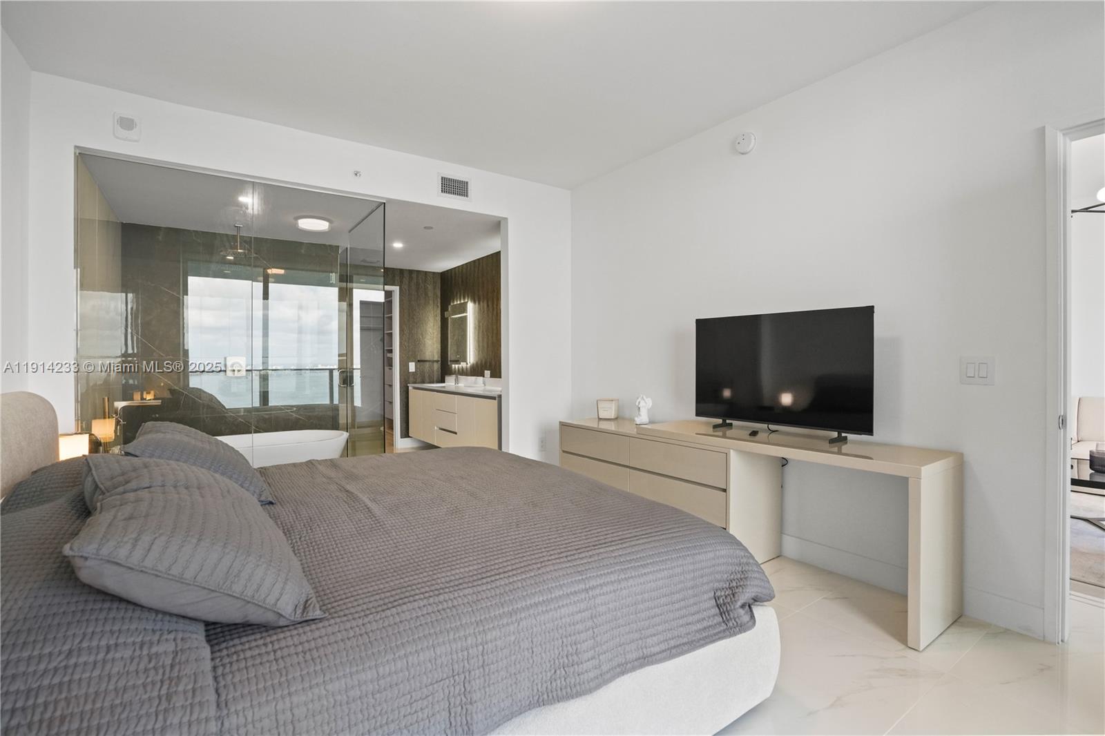 700 Northeast 24th Street, Unit 3905 Miami, FL 33137 - Photo 16 of 46 a bedroom with a bed and a television in it