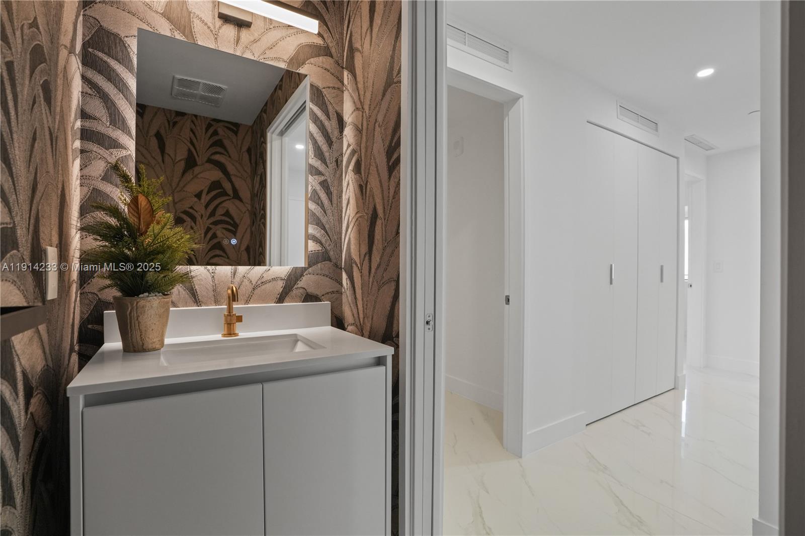 700 Northeast 24th Street, Unit 3905 Miami, FL 33137 - Photo 22 of 46 a bathroom with a sink and a mirror