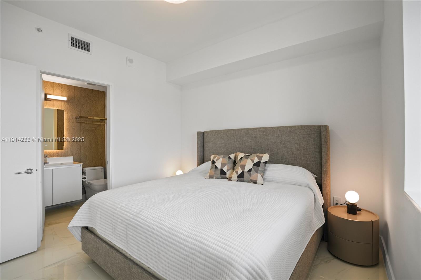 700 Northeast 24th Street, Unit 3905 Miami, FL 33137 - Photo 25 of 46 a bedroom with a bed and a lamp