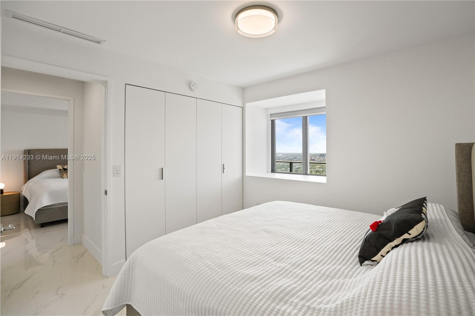 700 Northeast 24th Street, Unit 3905 Miami, FL 33137 - Photo 28 of 46 a bedroom with a bed and a window