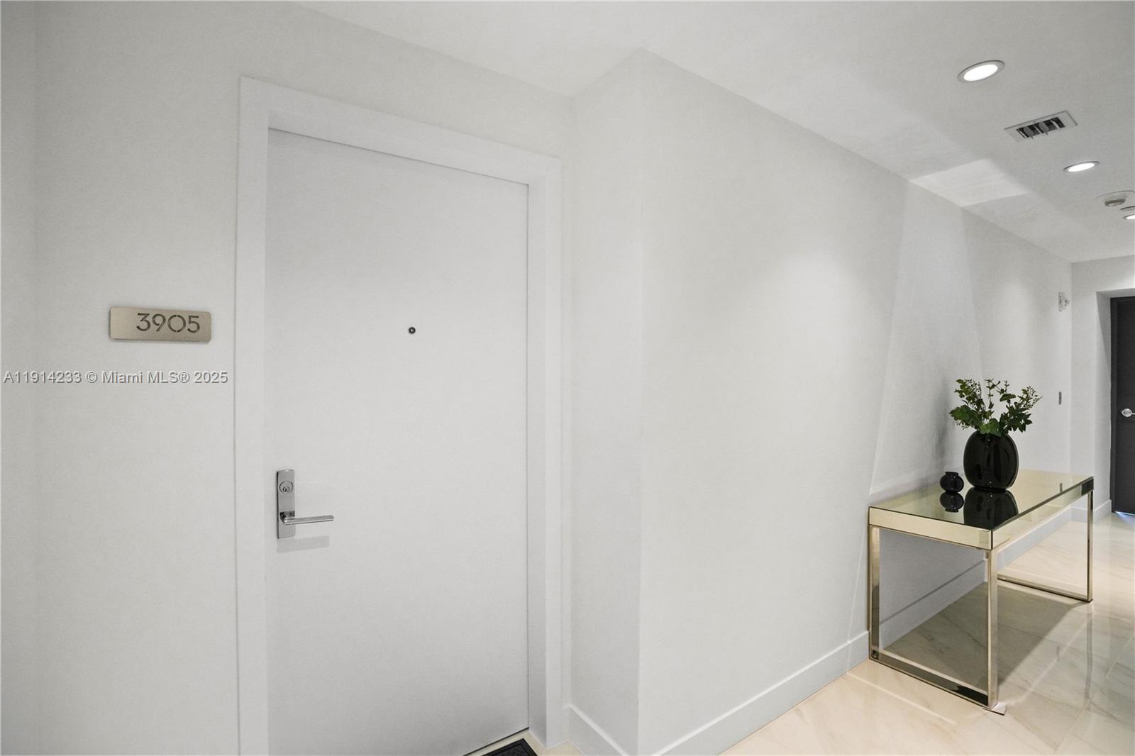 700 Northeast 24th Street, Unit 3905 Miami, FL 33137 - Photo 4 of 46 a room with a table and a potted plant