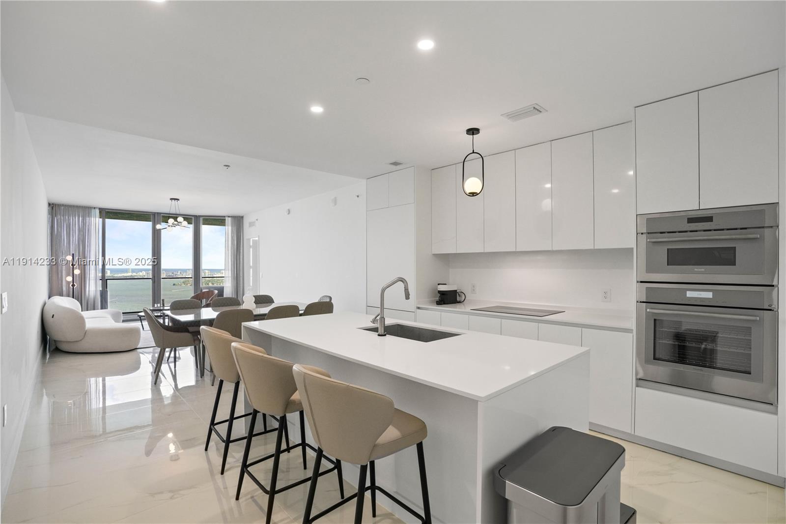 700 Northeast 24th Street, Unit 3905 Miami, FL 33137 - Photo 6 of 46 a kitchen that has a table and chairs in it