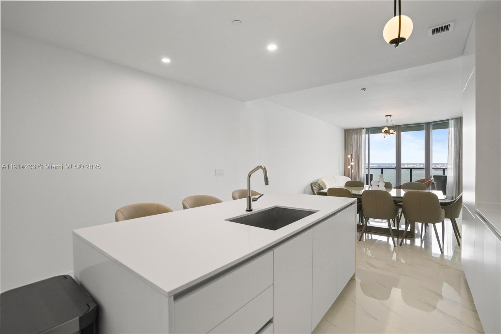 700 Northeast 24th Street, Unit 3905 Miami, FL 33137 - Photo 9 of 46 a living room with furniture a window and a chandelier