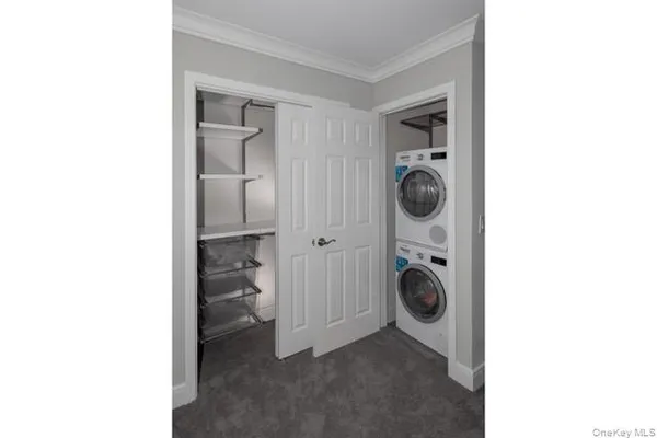 a view of a hallway with washer and dryer