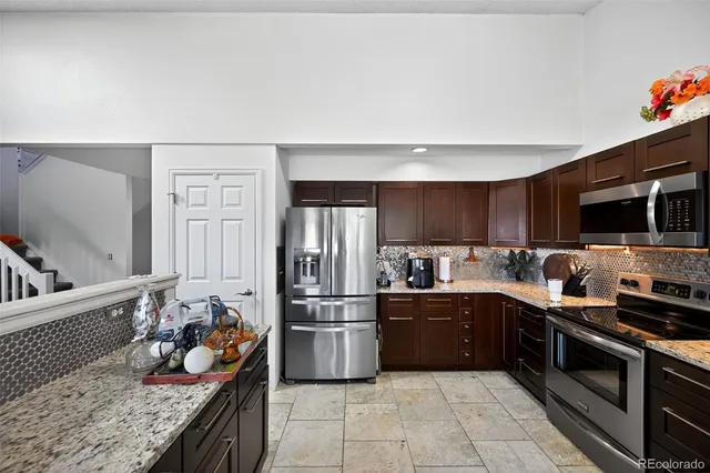 a kitchen with lots of counter top space and appliances