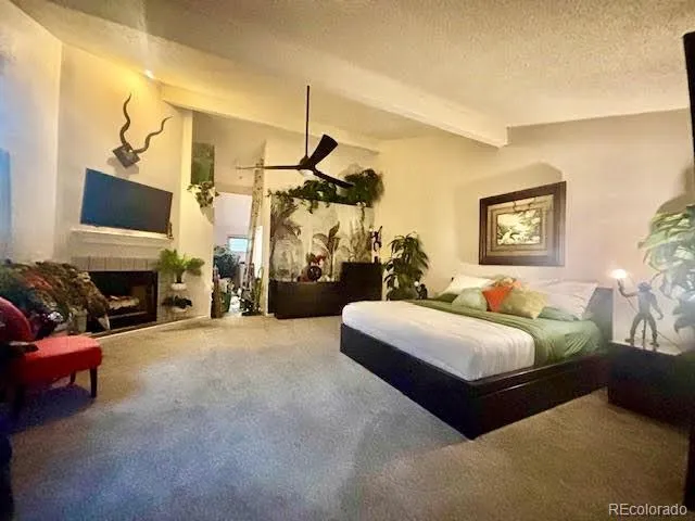 a spacious bedroom with a bed couch and a window