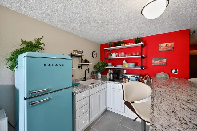 a room with furniture a mirror a lamp and a sink