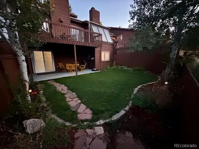 a view of a backyard with garden and patio
