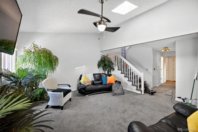 a living room with furniture and a potted plant
