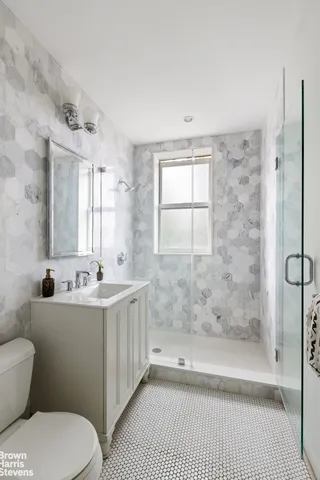 a bedroom with two beds and a large window