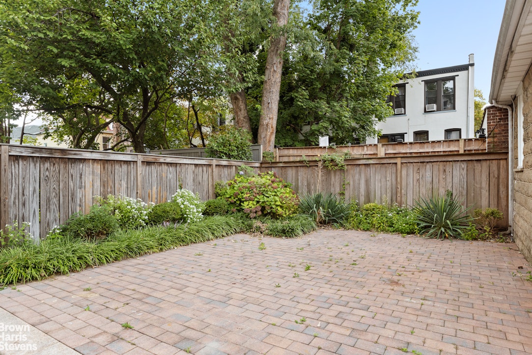 36 Rutland Road Brooklyn, NY 11225 - Photo 14 of 16 a view of a backyard with table and chairs a wooden fence