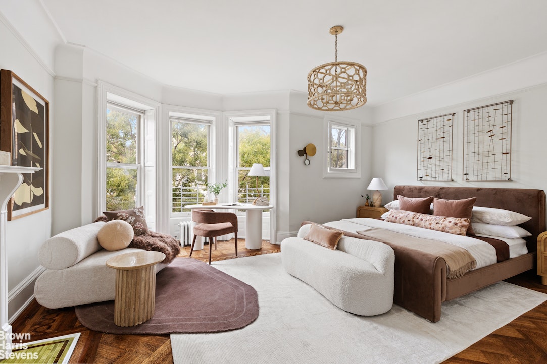 36 Rutland Road Brooklyn, NY 11225 - Photo 4 of 16 a bedroom with a bed and a chandelier