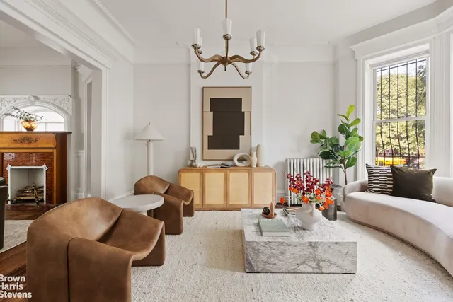a view of a dining room with furniture a chandelier and wooden floor