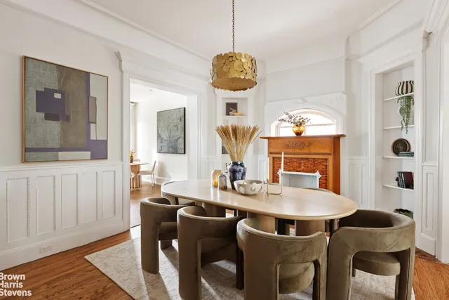 a view of a dining room with furniture a chandelier and wooden floor
