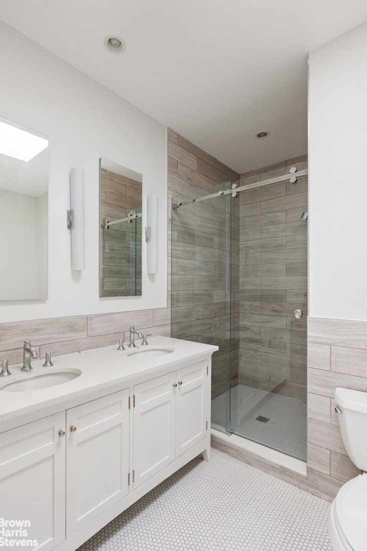 36 Rutland Road Brooklyn, NY 11225 - Photo 9 of 16 a bathroom with a shower sink vanity and mirror