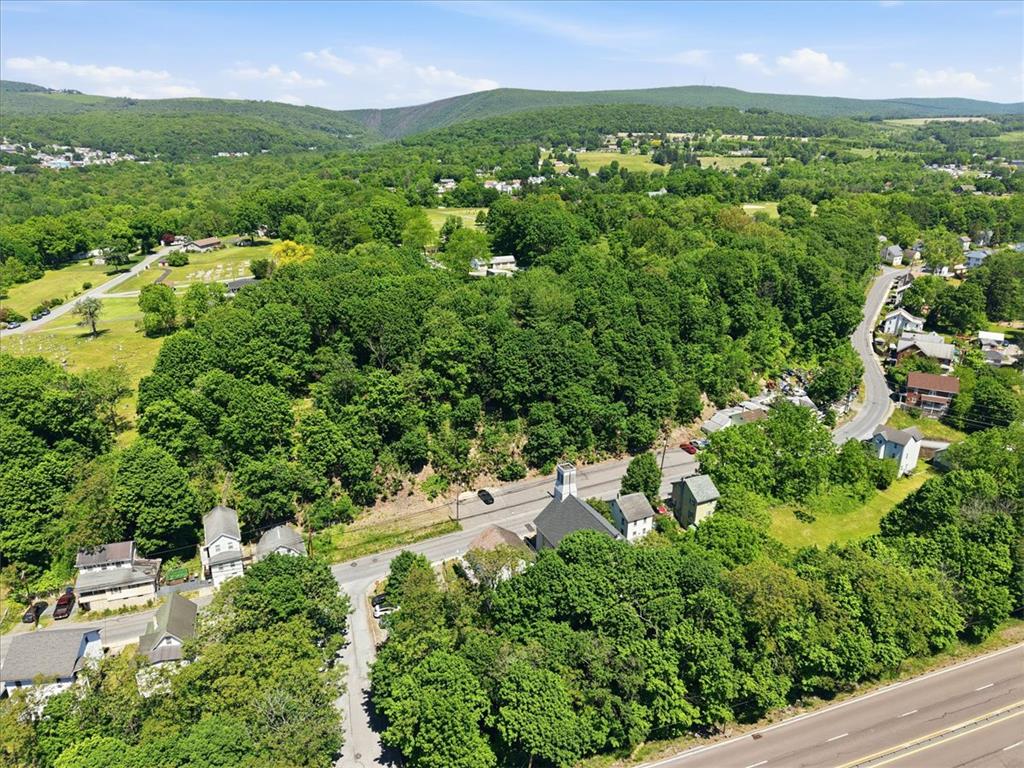 167 Main Road Lehighton, PA 18235 - Photo 41 of 41 Rolling hills and mature trees frame this scenic neighborhood, featuring a charming church and homes nestled along winding roads.
