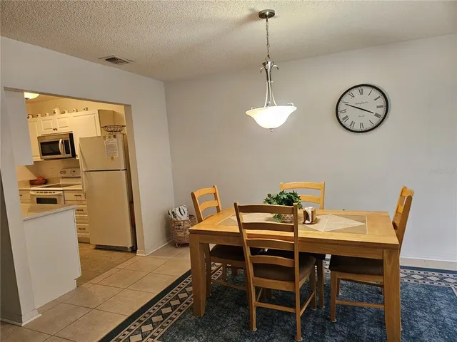 a dining room with furniture and a clock