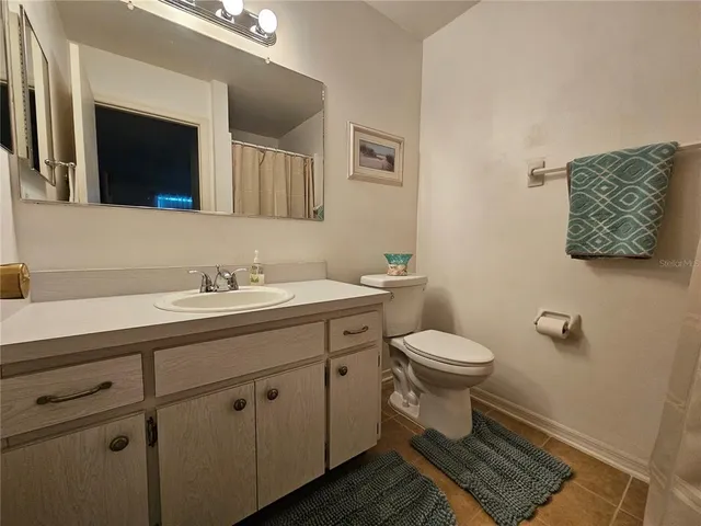 a bathroom with a shower and a wooden floor
