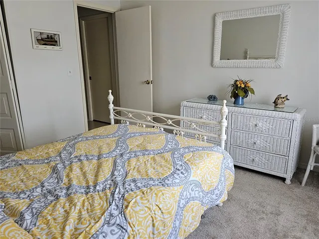 a bedroom with a bed a dresser and window